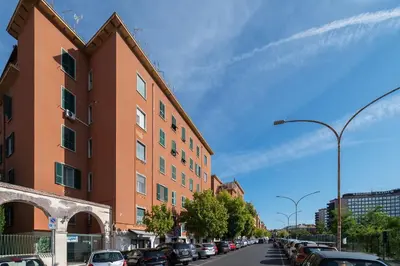 a street with cars parked on the side of a building at GuestHost - Comfy Apartment Garbatella Roma in Rome