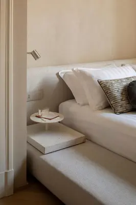 a bed with a side table next to a bed at Hotel Trame in Rome