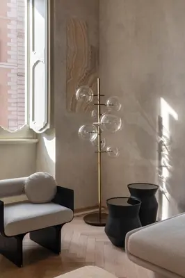 a room with a bed and a chair and a lamp at Hotel Trame in Rome