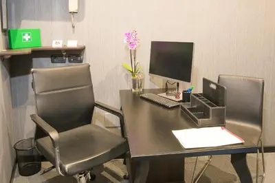 an office with a desk with a computer and two chairs at Rometobe in Rome