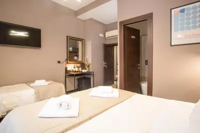 a hotel room with two beds with towels on them at Rometobe in Rome