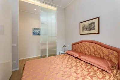 a bedroom with a bed and a glass wall at La terrazza al Cupolone in Rome