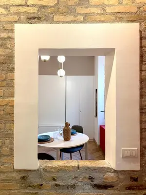 a dining room with a table and a mirror at Salotto34 in Rome