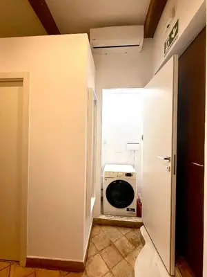 a laundry room with a washing machine in a doorway at Salotto34 in Rome