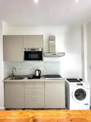 a kitchen with a washing machine and a washer at Callas Luxury Apartment in Rome