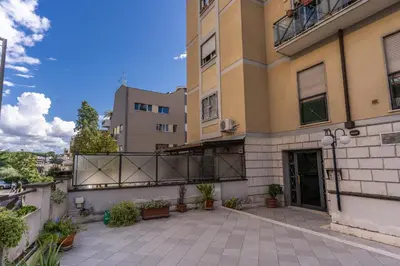 a large building with a patio in front of it at Lovely flat near Vaticano in Rome