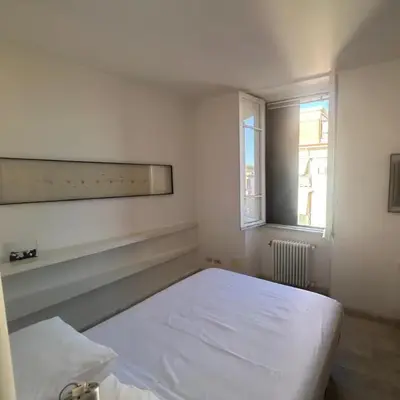a white room with a bed and a window at Monastery's View Home in Rome