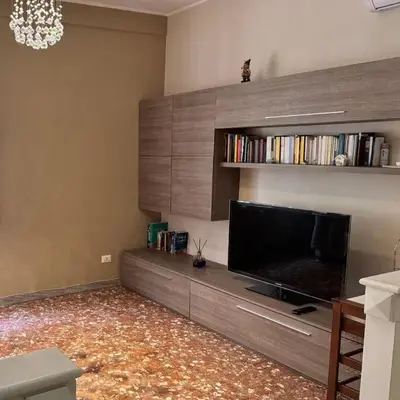 a living room with a large flat screen tv at Colle Aurelio Home in Rome
