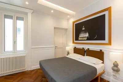 a bedroom with a bed and a television on the wall at Amazing Vittoriano in Rome