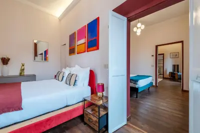 a bedroom with a white bed and a table at Casa Mia Trastevere in Rome