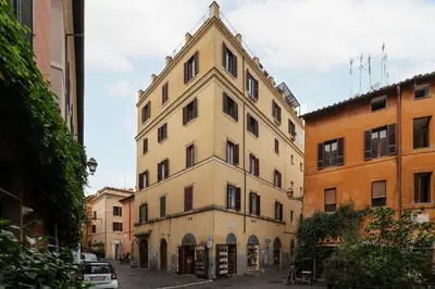 a tall white building in the middle of a street at Casa Mia Trastevere in Rome