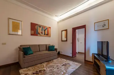 a living room with a couch and a flat screen tv at Casa Mia Trastevere in Rome