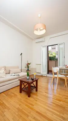 a living room with a couch and a table at Zen 31 - Colosseum cozy apartment in Rome