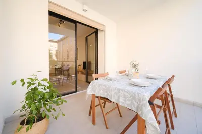 a dining room with a table and chairs and a plant at Bonelli 67 Apartment in Rome