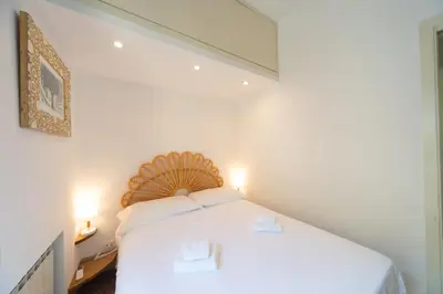 a bedroom with a white bed in a room at My Monti Charming Holiday Home in Rome