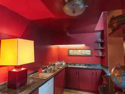 a bedroom with a bed with a red bedspread at Giordano Segreto in Rome