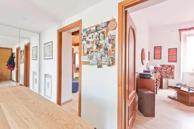 a living room with a door open to a hallway at GattaGuest in Rome