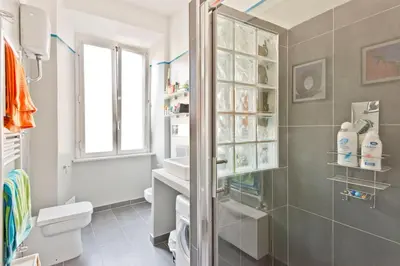 a bathroom with a shower and a sink and a toilet at GattaGuest in Rome