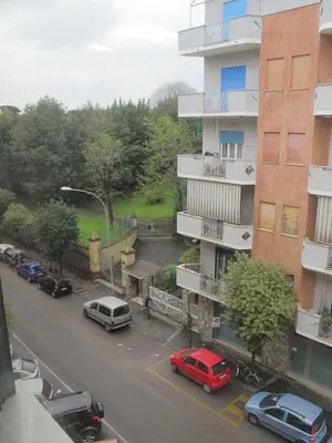 a city street with cars parked in front of a building at GattaGuest in Rome