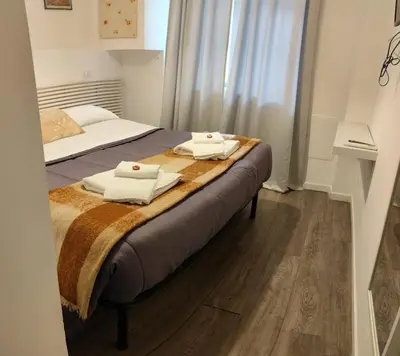 a bedroom with a bed with two towels on it at vatican house tolemaide ottaviano in Rome