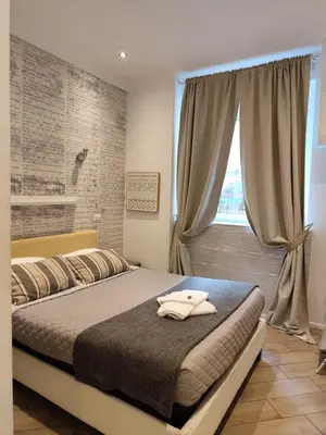 a bedroom with two beds and a window at vatican house tolemaide ottaviano in Rome