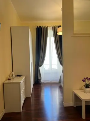 a living room with a large window and a wooden floor at Manrique home in Rome
