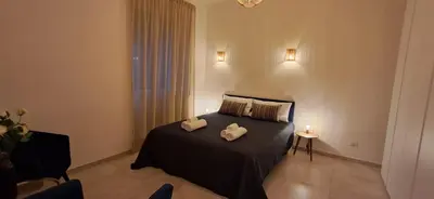a bedroom with a bed with two towels on it at Casa Carmine in Rome