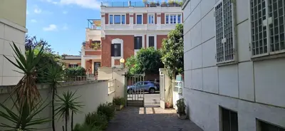 an alley in a city with buildings and a car at Casa Carmine in Rome