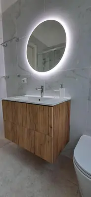 a bathroom with a sink with a mirror and a toilet at Casa Carmine in Rome