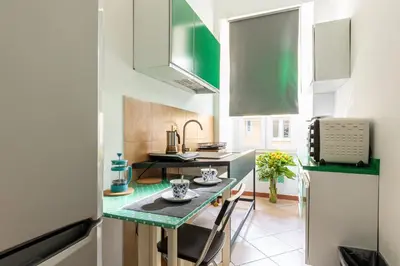 a small kitchen with a table and a sink at Rome centre Vatican cozy apartment in Rome