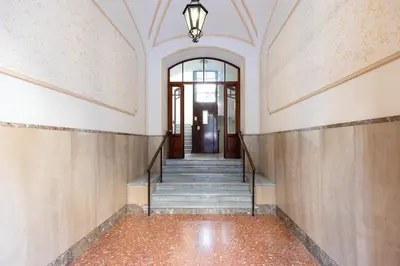 an empty hallway with stairs and a chandelier at Rome centre Vatican cozy apartment in Rome