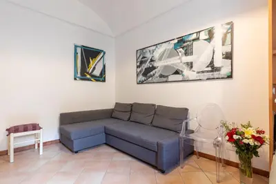 a living room with a couch and a table at Rome centre Vatican cozy apartment in Rome