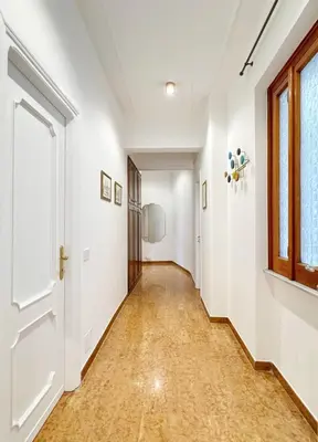 an empty hallway with a door and a window at Merulana 13 in Rome