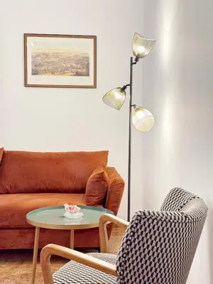 a living room with a couch and a table and chairs at Merulana 13 in Rome