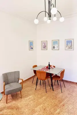 a dining room with a table and chairs at Merulana 13 in Rome