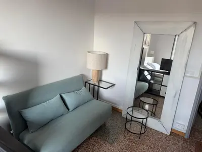 a living room with a couch and a mirror at Cozy Home Flaminio in Rome