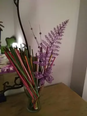 a vase filled with colorful flowers on a table at Next Stop Roma Affittacamere Casilino in Rome