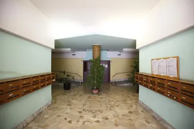 a hallway with a plant in the middle of a building at Next Stop Roma Affittacamere Casilino in Rome