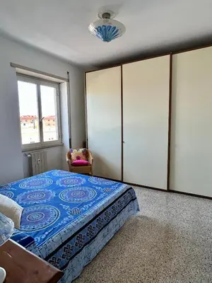 a bedroom with a large bed and a window at Casa vacanze Morabito in Rome
