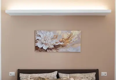 a painting hanging on a wall above a couch at A Casa di Giò in Rome