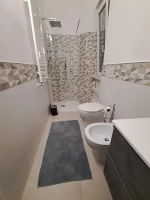 a bathroom with a toilet and a sink and a shower at A Casa di Giò in Rome