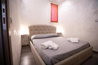 a bedroom with a bed with two towels on it at Monteverde Charme -ROMA- in Rome