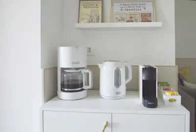 a kitchen with two white appliances on a white cabinet at TraStella, Trastevere di charme, balcone & hammam in Rome