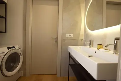a bathroom with a sink and a washing machine at Claudia 2BR Holiday Home in Rome