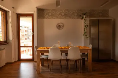 a dining room with a table with white chairs at Domus Piscariae in Rome