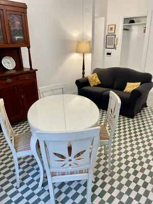 a living room with a white table and chairs at Apartment Sora Marcella, Testaccio in Rome