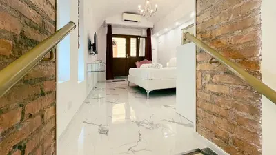 a living room with a stone floor and a brick wall at Domus Jana 30 in Rome