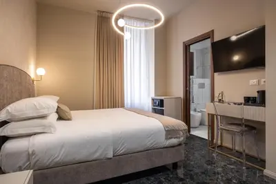 a hotel room with a bed and a bathroom at Roma suite hotel in Rome