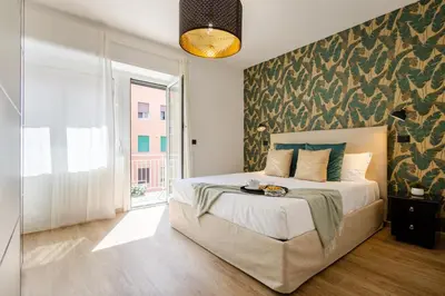 a bedroom with a bed with a green wall at Yasmine Luxury Apartment in San Giovanni in Rome