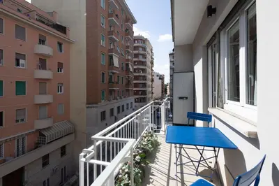 a balcony with blue chairs on a building at Yasmine Luxury Apartment in San Giovanni in Rome